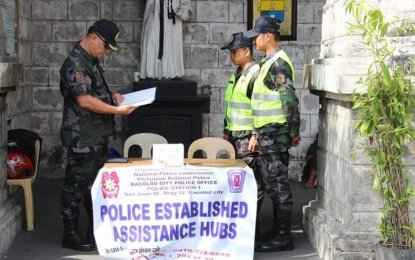 <p>POLICE ASSISTANCE. Senior Superintendent Francisco Ebreo (left), officer-in-charge of Bacolod City Police Office, inspects the police assistance hub at San Sebastian Cathedral on Wednesday (March 28, 2018). <em>(Photo courtesy of Bacolod City Police Office) </em></p>